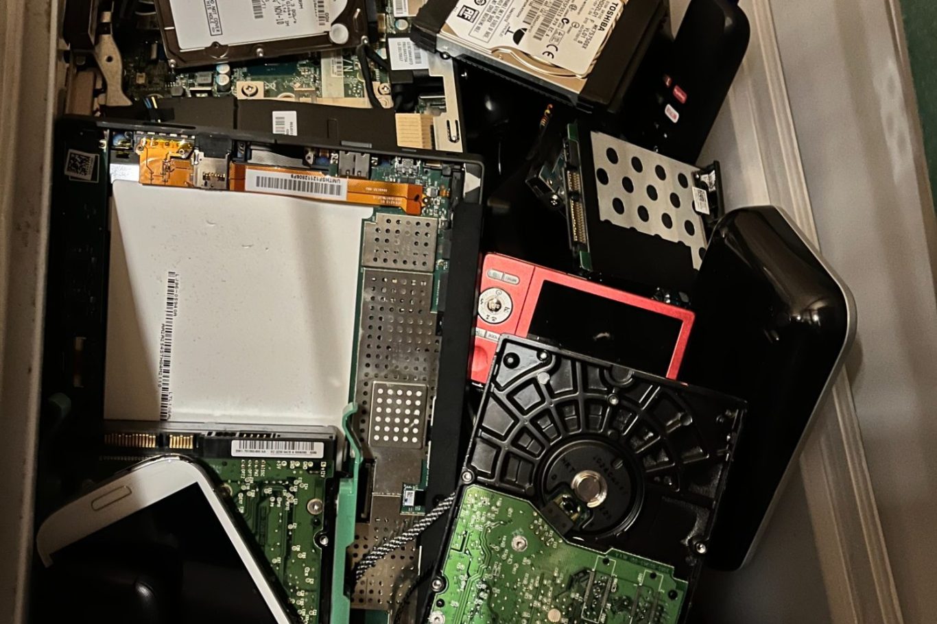 Hard drive shredding, iphone shredding, various electronic media ready to be confidentially shredded to protect privacy Shredded electronics