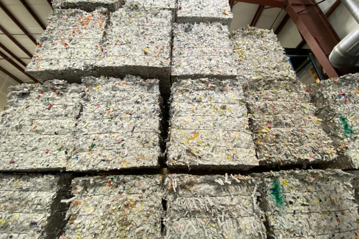 Bales of shredded paper stacked, ready to be shipped to recycling Stack of shredded paper